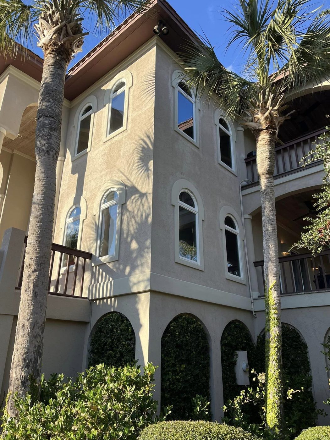 Residential brick home entry with tinted glass doors