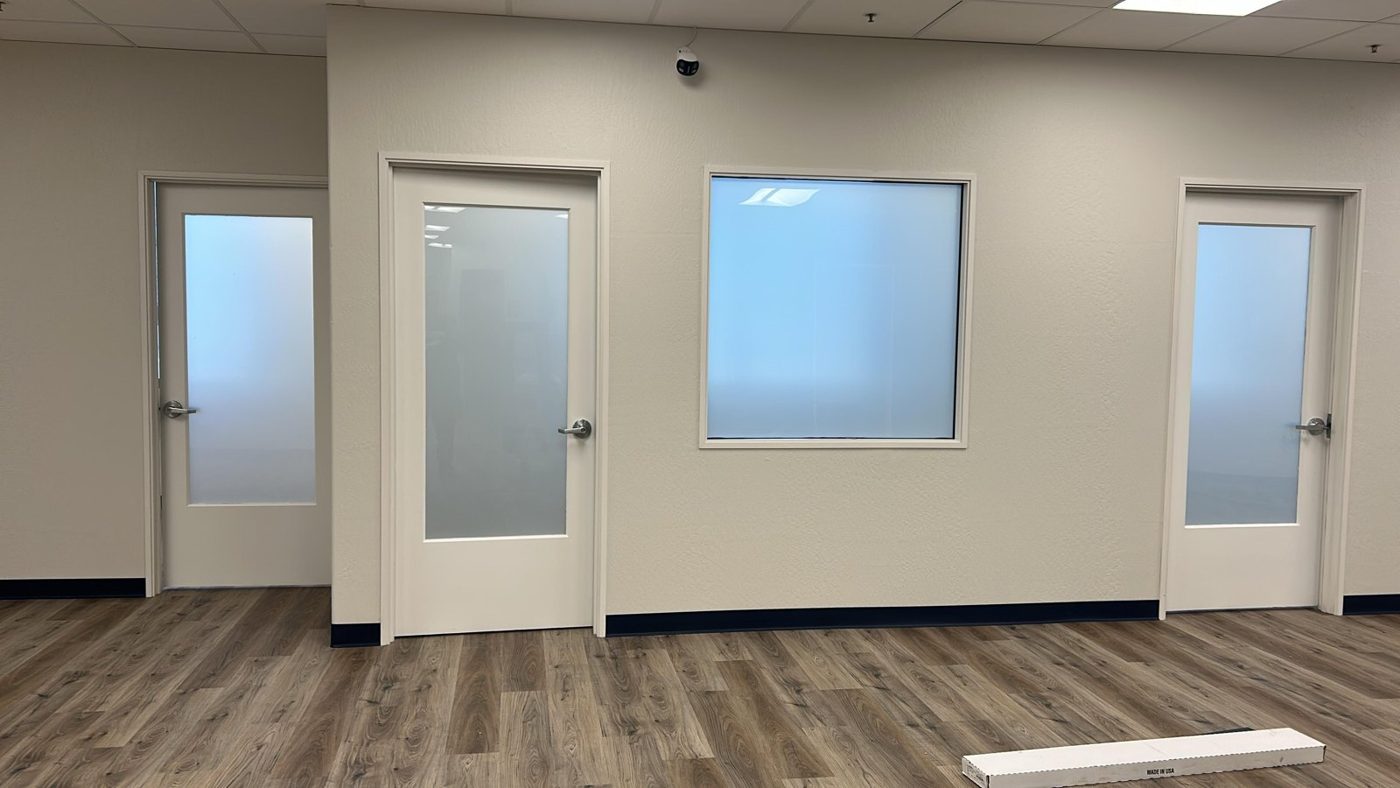 Office suite interior with frosted privacy film on partition glass