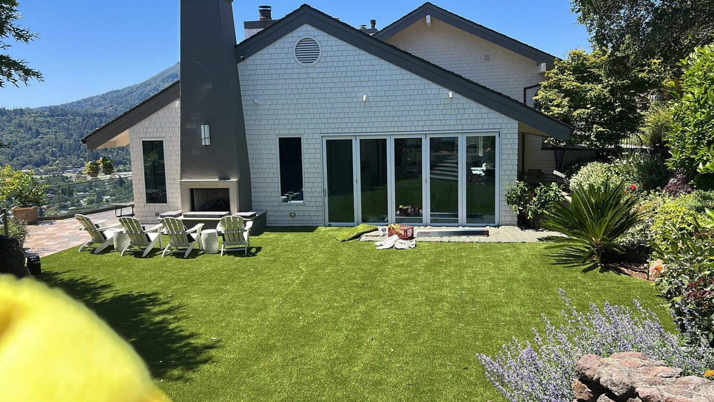 Backyard artificial turf and patio protected by turf protection window film