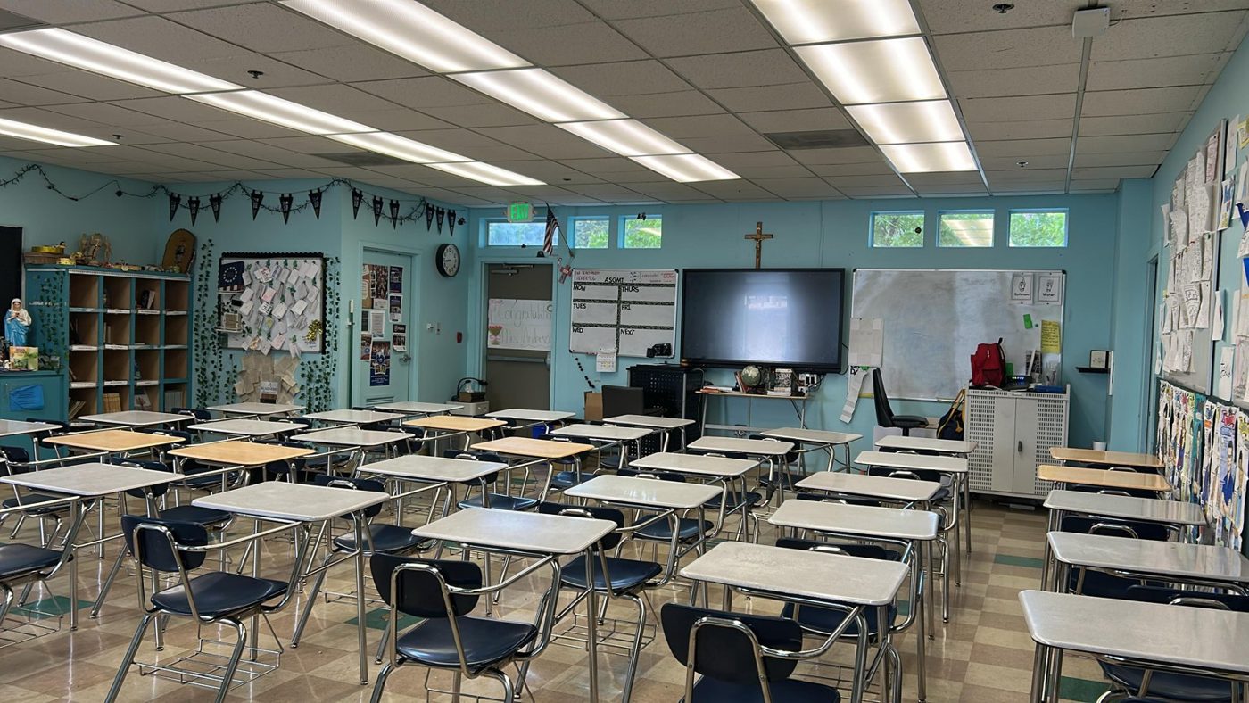 Classroom with rows of desks and tinted exterior windows