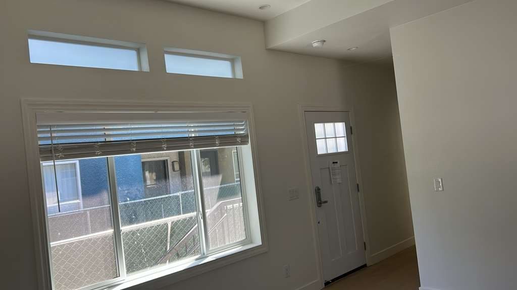 Interior room with tinted windows and a glazed entry door
