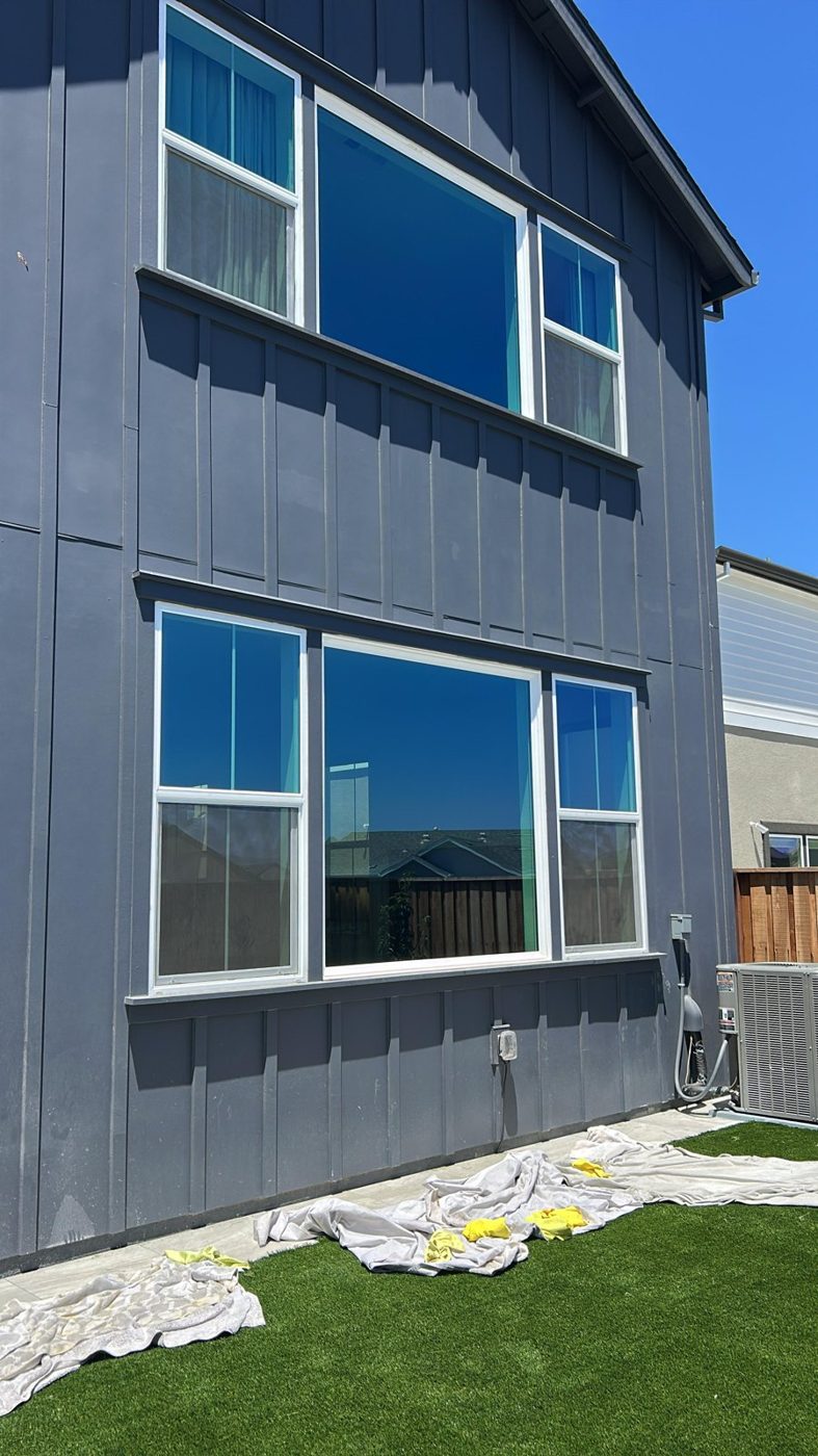 Two-story home with turf protection window film on the rear glazing