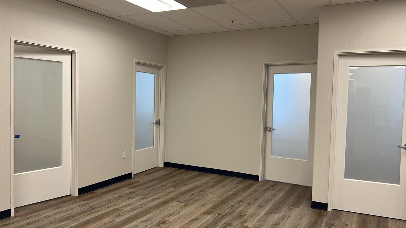 Corridor of private offices with frosted glass film