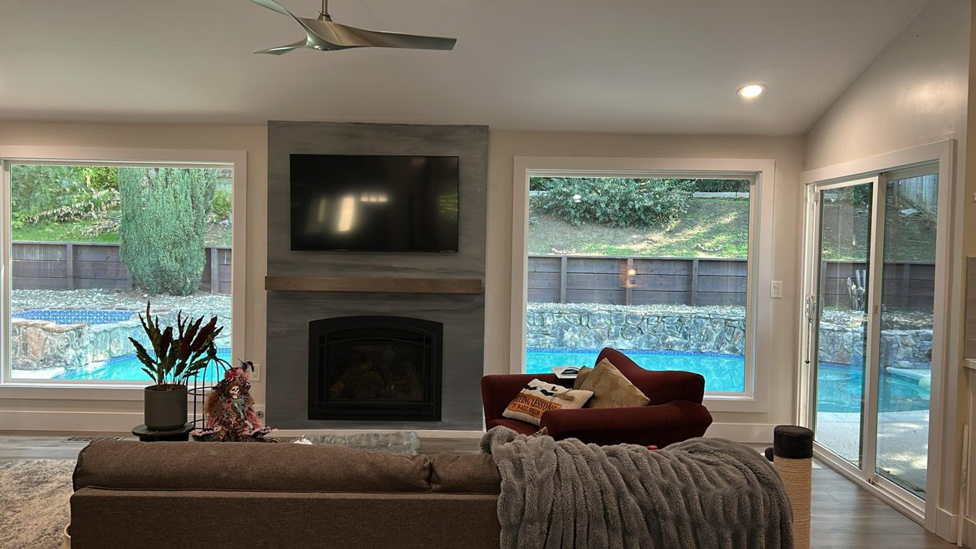 Open kitchen and great room with tinted windows and sliding doors