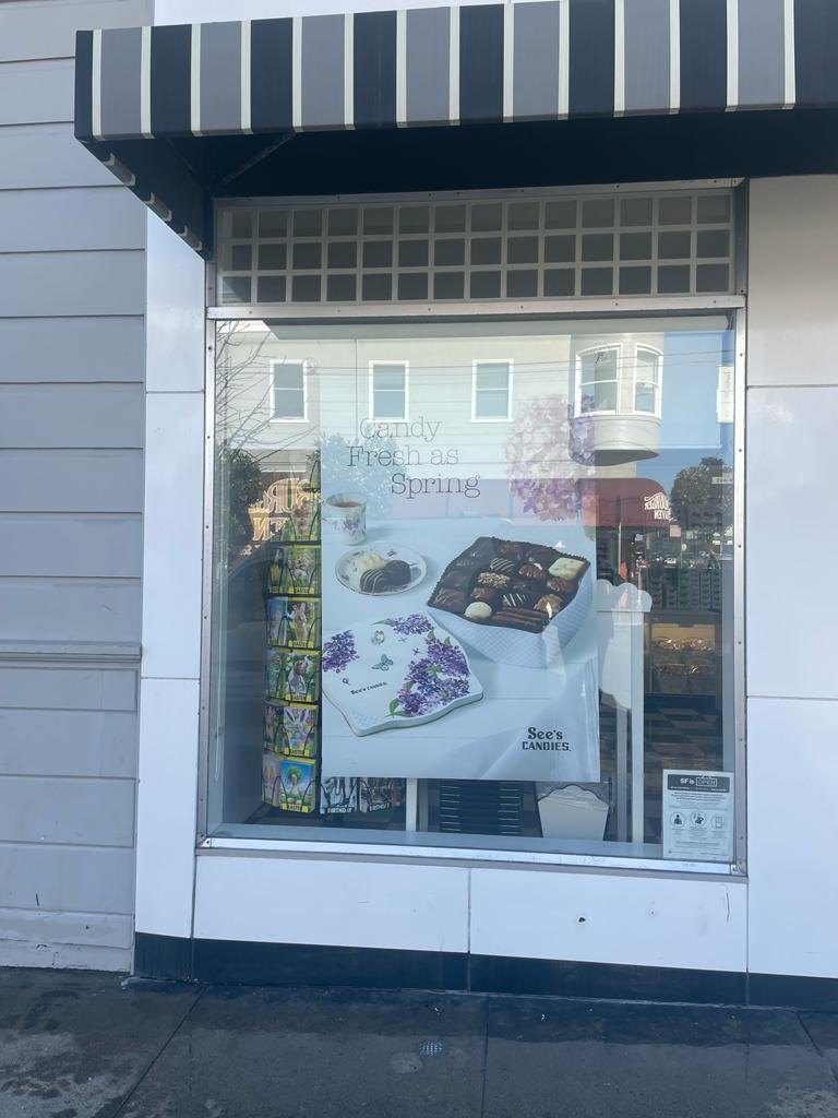 Retail display window with sacrificial anti-graffiti film